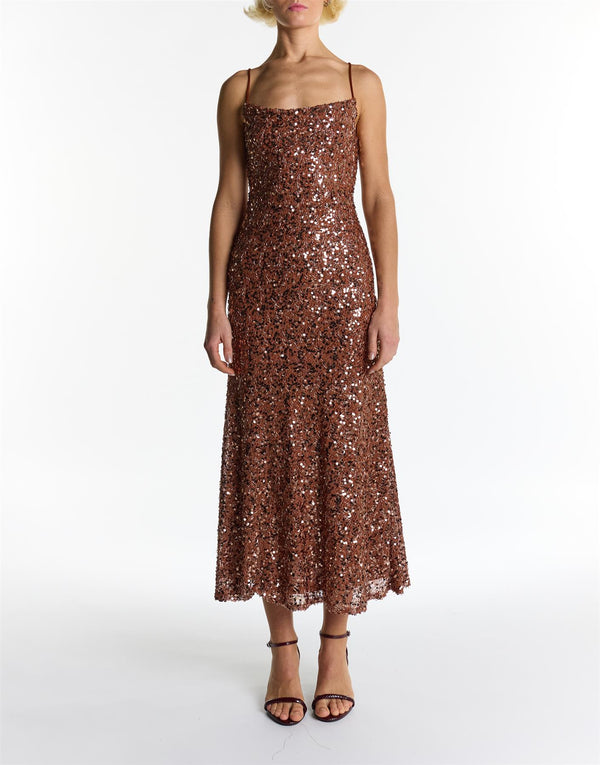 Woman wearing a sparkly brown dress on a white background mocha brown sequins